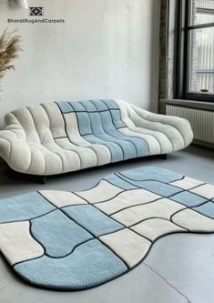 a living room with a couch and rugs on the floor