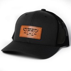 Introducing the ultimate accessory for every hunting enthusiast dad: the Leather Patch Hat. This rugged yet stylish hat is designed with the outdoor-loving dad in mind. Crafted from durable, high-quality materials, it features a sleek leather patch that proudly displays a hunting-themed design, adding a touch of sophistication to its rustic appeal. The Leather Patch Hat offers a comfortable fit with an adjustable strap, ensuring it stays securely in place during all your dad's outdoor adventures. Its breathable fabric and classic design make it perfect for long days in the field, providing shade and protection from the elements. MESSAGE: Best Buckin Dad Ever. PRODUCT DETAILS: Material: Crafted from a high-quality blend of 60% Cotton and 40% Polyester, this hat features a breathable mesh ba Leather Hat With Curved Brim For Outdoor Activities, Black Leather Hats For Outdoor Activities, Black Leather Hat For Outdoor, Rugged Leather Hat With Patch, Rugged Leather Hat With Leather Patch, Adjustable Leather Baseball Cap For Outdoor, Adjustable Black Leather Baseball Cap, Black Leather Hat With Flat Brim, Black Leather Adjustable Baseball Cap