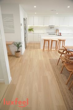 an open kitchen and dining room with wood flooring