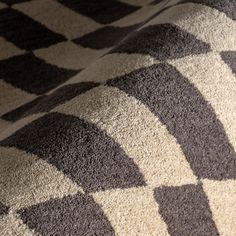 a black and white checkered blanket on top of a bed