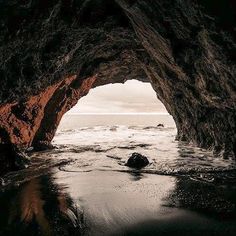 an ocean cave with water coming out of it