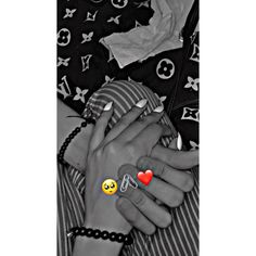 two hands holding each other with hearts on their fingers and an emoticive sticker in the middle