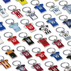 a bunch of key chains that have different colors and numbers on them, all hanging from the same metal ring