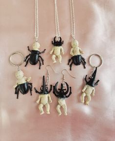 Super cute n creepy mutant beetle babies! Soooo creepycute and pastel goth! Each unique piece is handmade and one of a kind, some beetle babies are more beetle and some are more baby, some have baby bodies and some have bug bodies. They feature pinchers like a stag beetle or rhinocerous beetle, and have creepy beetle-like bodies and legs fusing with the human-like baby body parts. Keychains, necklaces, and earrings available!! Feel free to contact me about switching around the style for example swapping a necklace to a keychain. The beetle baby creatures measure approx 5cm in length. There are several styles available so please refer to the last photo when choosng a style number! :) They are a lovely gift for any pastel goth babe or appreciator of creepycute things! xoxo Quirky Handmade Halloween Jewelry, Cute Handmade Halloween Jewelry, Immaculate Vibes, Jewelry Keychain, Goth Necklace, Keychain Necklace, Stag Beetle, Creepy Cute, Pastel Goth