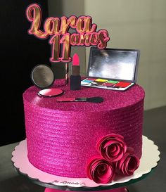 there is a pink cake that has lipstick and makeup on it with the words lora de mois