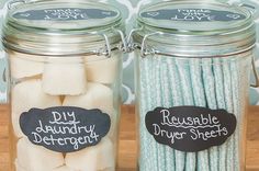 two jars filled with marshmallows on top of a wooden table