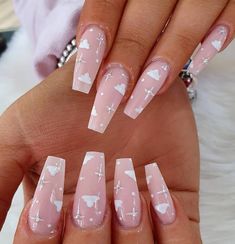 some pink and white nails with hearts on them