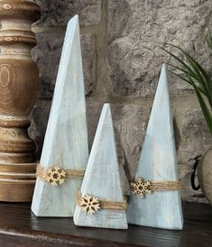 three small wooden cones are sitting on a table