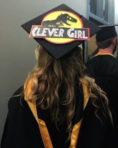 a person in a graduation cap that says clever girl on the back of their hat