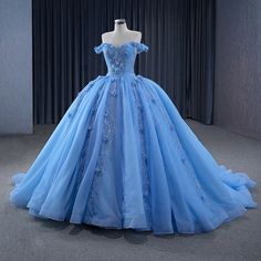 Step into a world of opulence and grace with this Elegant Blue Sequins Ball Gown. This dress is crafted from luxurious blue tulle and features a voluminous ball gown silhouette, flowing effortlessly into a dramatic cathedral train that adds an air of regal sophistication. The off-the-shoulder neckline enhances the dress’s romantic appeal, beautifully framing your shoulders while offering a flattering, feminine touch. The exquisite appliqued details and sparkling sequins on the bodice catch the l Sequin Ball Gown, White Homecoming Dresses, Blue Ball Gowns, Evening Party Dresses, Blue Homecoming Dresses, Stunning Prom Dresses, Quinceanera Dress, Future Children, Most Beautiful Dresses