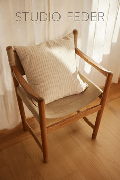 a chair with a pillow on top of it and the words studio feeder above it