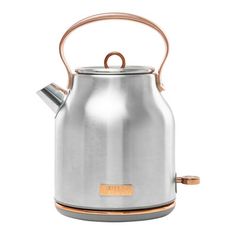 a stainless steel tea kettle with copper handle