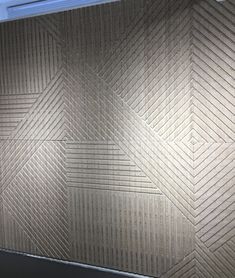 the wall is made out of cardboard and has an interesting pattern on it's surface