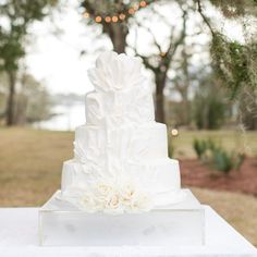 a white wedding cake sitting on top of a table