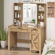 a wooden desk with a mirror on top of it next to a potted plant