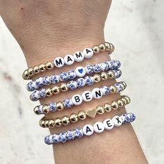 🔹 Design the custom name bracelet that you have always wanted! These beaded word bracelets stacking can be personalized so you can get exactly what you want. 🔹They are made with 6mm blue flower porcelain/ceramic beads, 6mm 18k gold plated beads, 7mm white acrylic beads with black letters and then strung together with a strong double-strung elastic cord. 🔹Please add each bracelet style separately to your cart. They will be sent to you as a stack. If you want all six bracelets, please choose the option for all six bracelets, otherwise you will receive the single styles that you purchased. 🔹Each custom beaded bracelet stack is packed in a gift box wrapped in organza ribbon and a handwritten message can also be included. It makes the perfect gift for yourself or for Christmas, a baby showe Personalized Name Beaded Bracelets For Mother's Day, Adjustable Stackable Name Bracelet As Personalized Gift, Adjustable Stackable Name Bracelet For Personalized Gift, Adjustable Stackable Name Bracelet, Personalized Mother's Day Beaded Name Bracelets, Customizable Blue Jewelry For Mother's Day, Customizable Name Bracelet With Round Beads As Personalized Gift, Custom Name Friendship Bracelets For Mother's Day, Customizable Adjustable Stretch Bracelet For Mother's Day