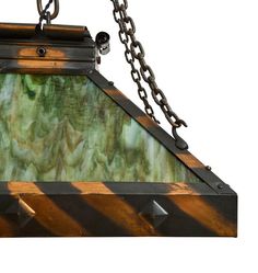 a stained glass light hanging from a chain