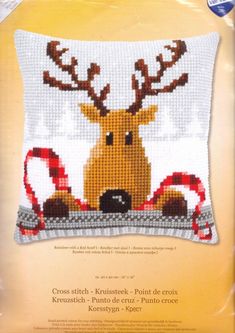 a cross stitch pillow with a reindeer on it