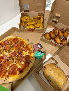 three pizzas in boxes with different toppings on the top and bottom one has chicken wings