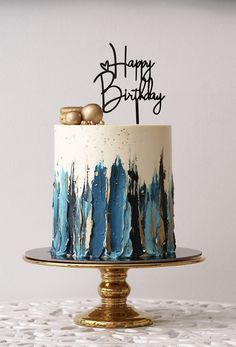 a birthday cake decorated with blue and gold icing