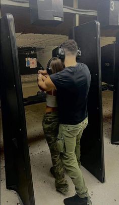 a man and woman are aiming at something