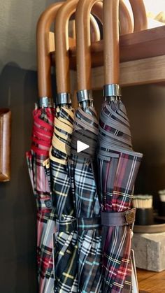 several umbrellas are hanging on a rack in the kitchen