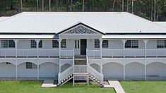 an aerial view of a white building with balconies