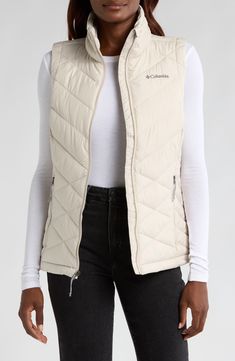 This quilted vest combines thermal reflective technology and plush fill so you'll stay warm to your core on trail walks or strolls through town. A cozy, fleece lined collar brings warmth up close when you need it most and front zip pockets let you carry the essentials. 25" length Front zip closure Stand collar Water repellent Front zip pockets Lined, with polyester fill 100% polyester Machine wash, tumble dry Imported Winter Hiking Vest Outerwear, Winter Hiking Outerwear Vest, Sleeveless Outerwear With Fleece Lining For Hiking, White Sleeveless Outdoor Outerwear, Winter Windproof Hiking Vest, Nylon Vest For Outdoor Activities In Fall, Winter Hiking Vest With Fleece Lining, Nylon Vest For Fall Outdoor Activities, Winter Hiking Windproof Vest