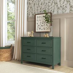 a green dresser sitting in front of a window