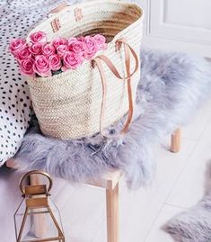 a bag sitting on top of a chair next to pillows