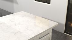 a white marble counter top in a room with tile flooring and walls behind it