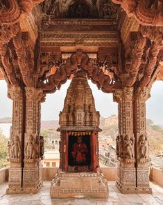 an intricately carved building with columns and pillars