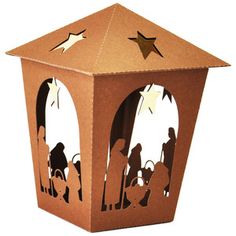 a brown paper lantern with nativity scene cut out of it's sides and on top