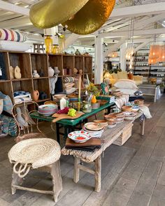 a room filled with lots of different types of furniture and decor on top of wooden floors