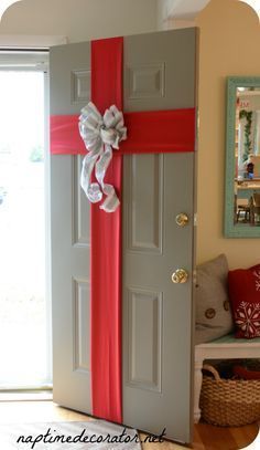 the door is decorated with red and white ribbons