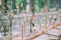 the table is set with candles and flowers