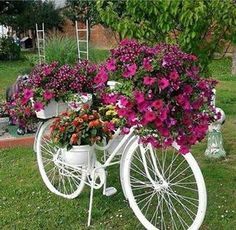 a white bicycle with flowers on the back