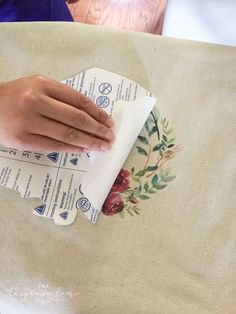 someone is cleaning the table cloth on top of another piece of paper that has been folded over it