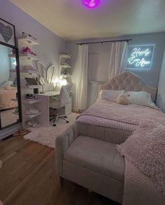 a bedroom with a bed, desk and mirror