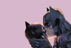 a couple of cats kissing each other in front of a pink background with the words batman written on it