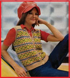 a woman sitting on top of a yellow car wearing a red hat and sweater vest