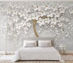 the bedroom is decorated with white flowers on the wall, and there are two tables in front of the bed