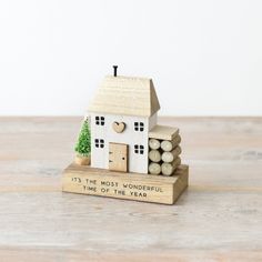 a small wooden house sitting on top of a table