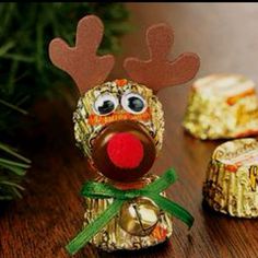 a reindeer made out of candy sitting on top of a table next to christmas decorations