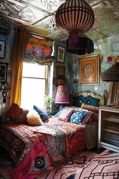 a bedroom with a bed, lamps and pictures on the wall