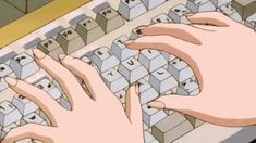 someone typing on a computer keyboard with their hands resting on the key board and fingers touching the keys