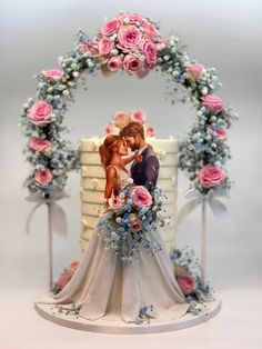 a wedding cake with a bride and groom on top