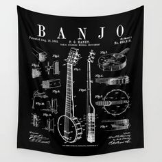 a black and white wall hanging tapestry with an old style guitar design on it's side