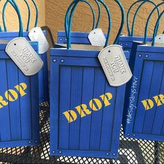 four blue shopping bags with tags on them