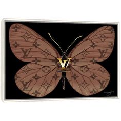 a pink butterfly with gold letters on it's wings canvas print wall art by panoramic images